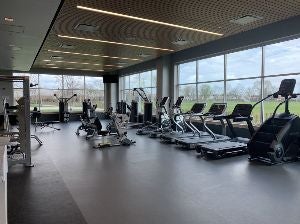 fitness center with rows of work out machines